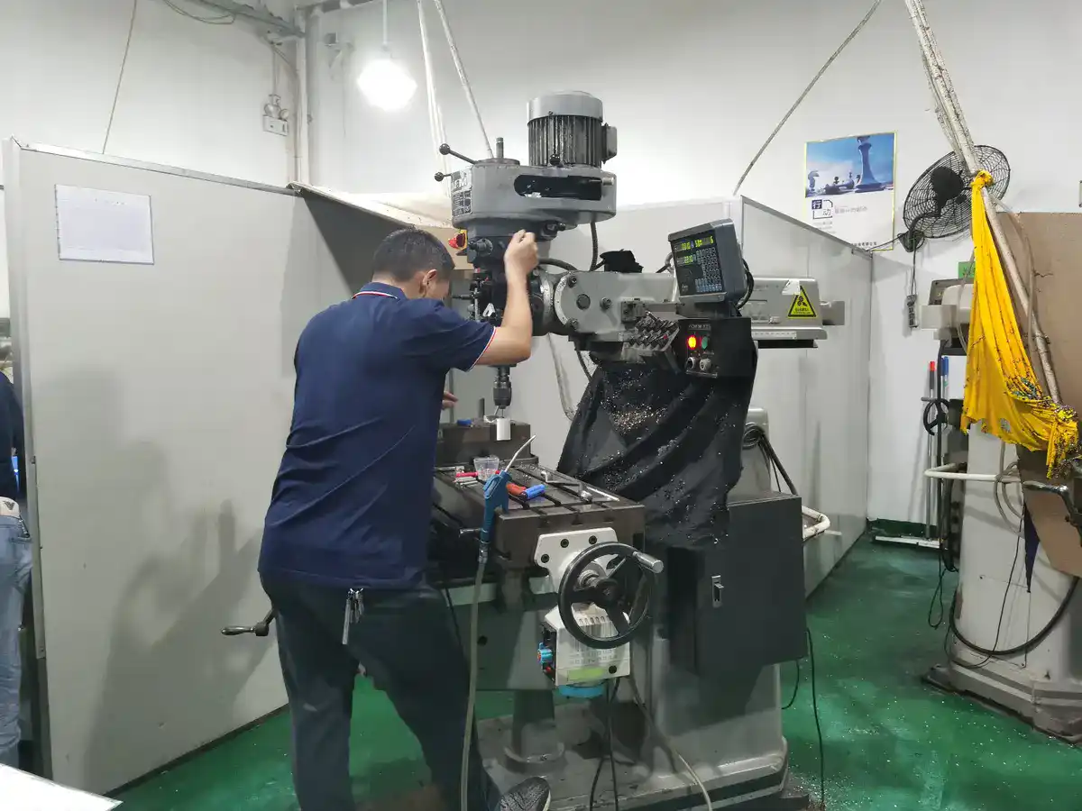 Weldo technician operating a manual milling machine