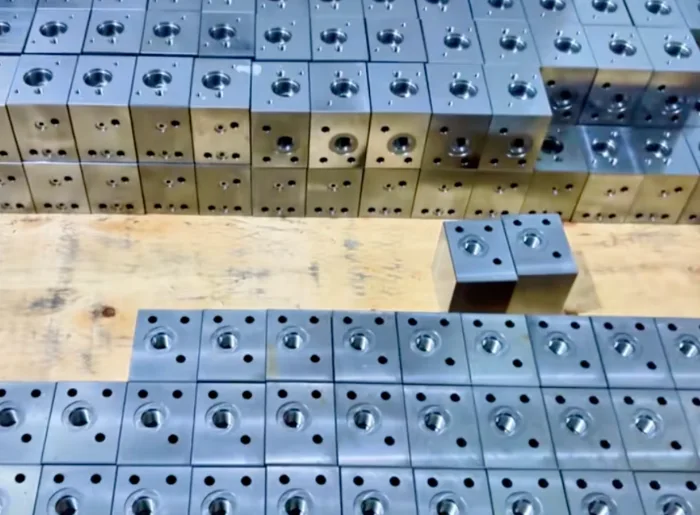 Metal hydraulic valve blocks with machined cavities